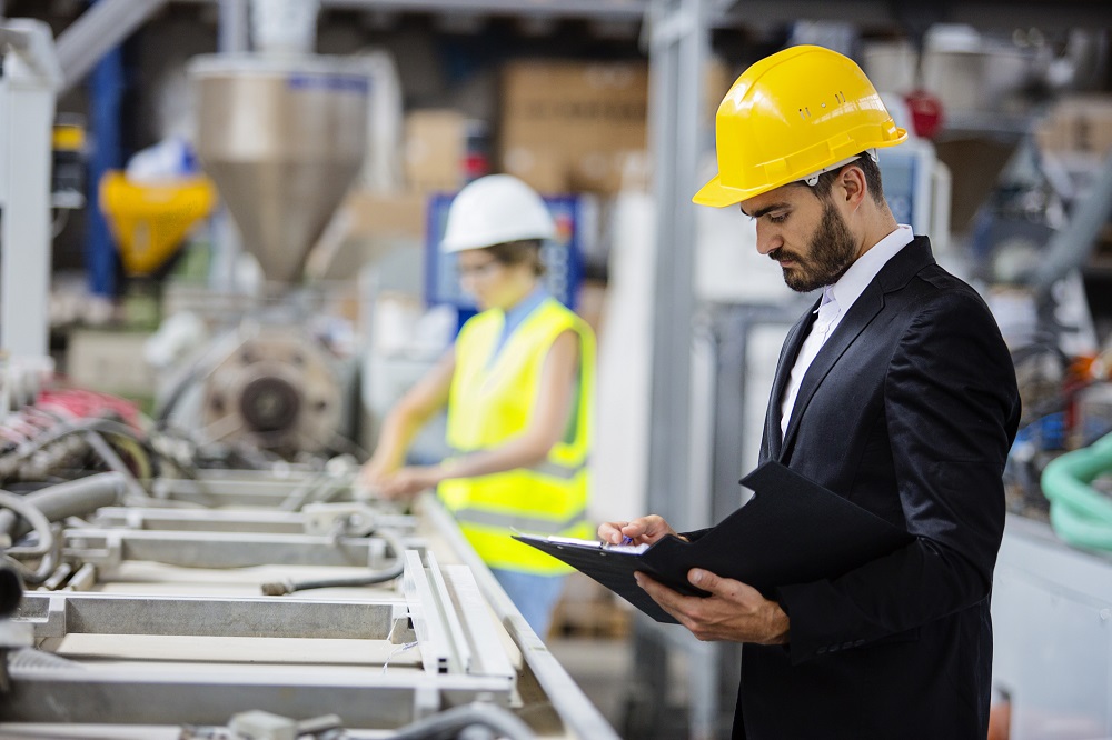 Young quality inspector checking production line