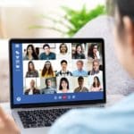 Person speaking with IT support on a videoconferencing platform.