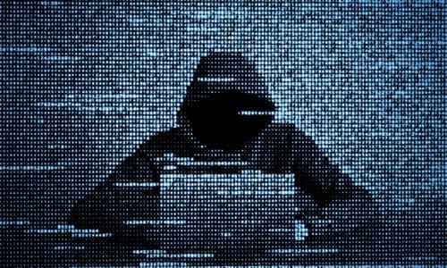 Hacker with computer symbolizing cyberattacks against Tech Service Providers, Microsoft Okta Lapsus$