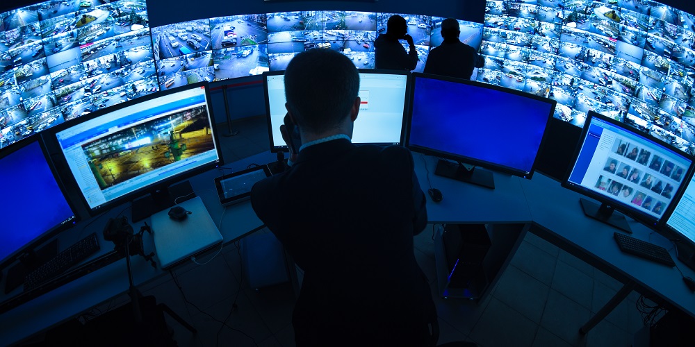 CCTV control room with different monitors and displays.