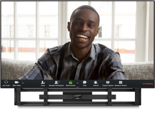 Leon Speakers and Bose Videobar below a tv with person smiling on screen.