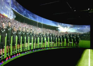 Curved display screen showcasing a rugby team