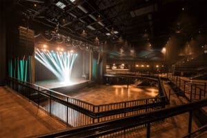 Performance stage lit up while seating area is empty.