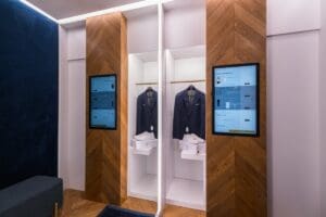 A fitting room with two business suits