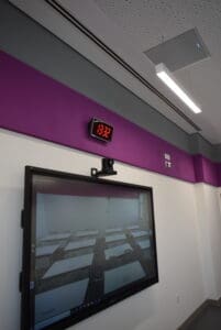 Video screen mounted on a classroom wall