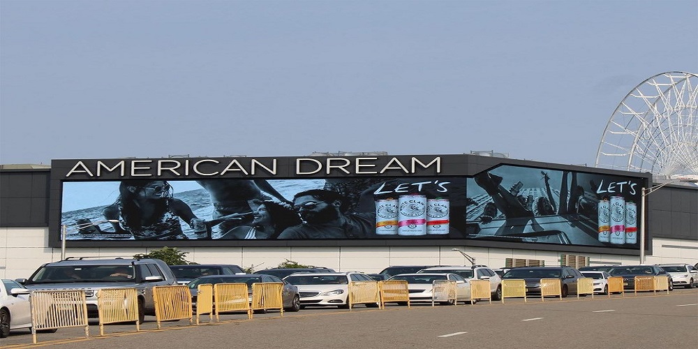 Screen displaying "American Dream" on road