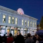 Building at night with projection displays on the windows.