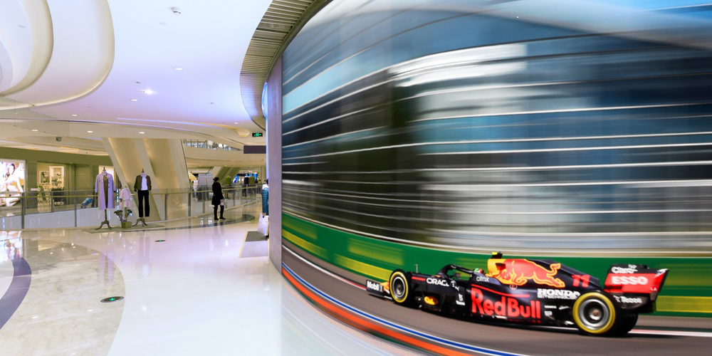 Shot of car zooming by on screen provided by PPDS for Red Bull Racing.