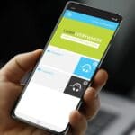 Arm holding a phone with screen displaying the app for Listen Technologies' Listen EVERYWHERE, the assistive learning system.