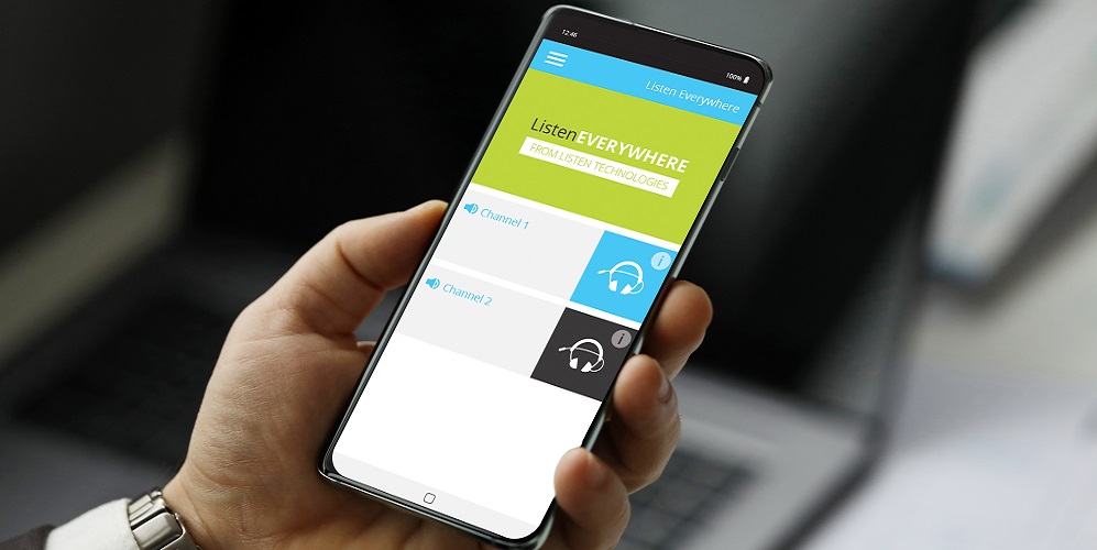 Arm holding a phone with screen displaying the app for Listen Technologies' Listen EVERYWHERE, the assistive learning system.