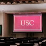 Projector screen provided by Spinitar showing USC logo in classroom.