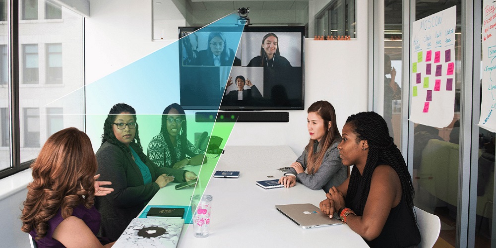 LeCAMbio Systems in action where Key Digital camera is focused on person in conference room. A green spotlight on the person from TOA soundbar indicates voice-tracking.