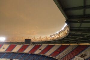 Football stadium against orange sky.