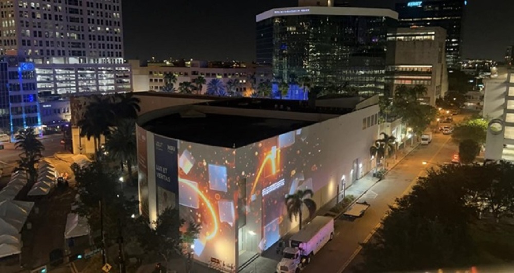 CODAsummit event images projected on a building wall.