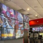 Football game being displayed on videowall by Sixth Sense at BarKada.