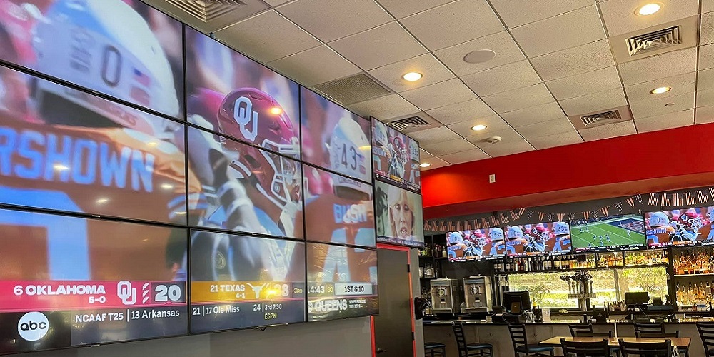 Football game being displayed on videowall by Sixth Sense at BarKada.