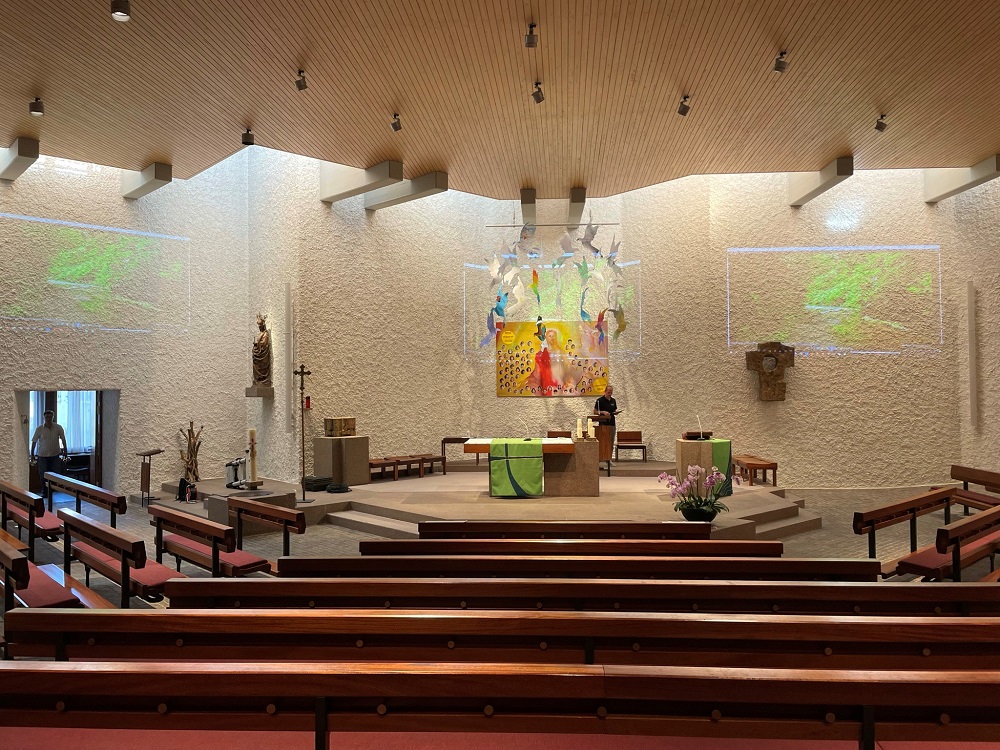 Podium of St. Katharina church with Renkus-Heinz speakers hanging from the ceiling.