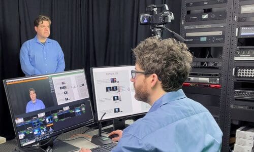 Person using Dante Studio, a Dante AV software solution on a laptop.