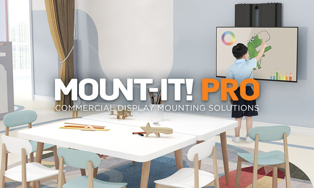 Mount-It! PRO Wall Mount in a classroom. A student is drawing on an interactive display fitted on the mount.