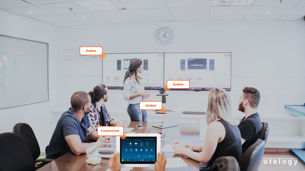 Participants in a room using Utelogy solutions.