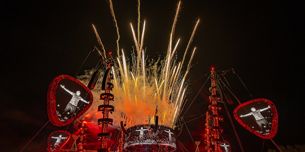 Ed Sheeran performing onstage with fireworks exploding behind and Meyer Sound loudspeakers placed near the stage.