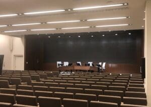 Empty auditorium with panel desk on stage.