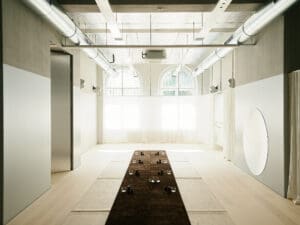 Spa area with low rise tables. On the ceilings are white, discreet loudspeakers.