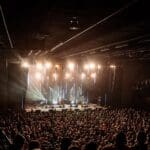 L-Acoustics system hanging overhead a crowded stage audience at Roadrunner.