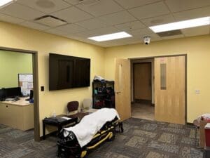 AMT simulation facility with medical bed and supplies.
