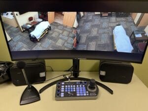 Monitors displaying feed from AMT facility rooms.
