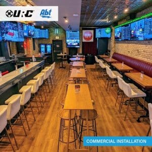 Empty tables at sports bar. URC and Abt logo appears on upper-left corner.