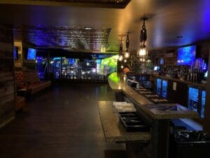 Goldfield entertainment venue bathed in golden and green lighting.
