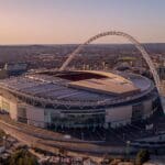 Aerial view of Wembley Stadium at dusk.