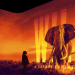 Illuminarium Atlanta poster. A silhouette observes an elephant at sunset. The words "WIL: A Safari Experience" appear at the bottom.