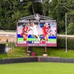 Video scoreboard featuring FSU soccer team.