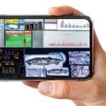 Person holding phone displaying RGB Spectrum Zio app.