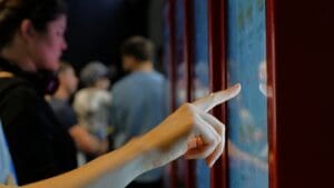 Person trying out an interactive digital board in a retail space.