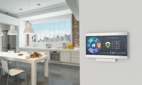 Interior of a smart home with a security system on the wall.