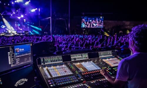 Sound engineer managing DiGiCo Quantum7 console at OneRepublic tour.