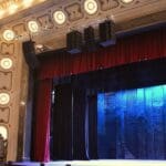 L-Acoustics Kara II speakers hanging from ornate ceiling.