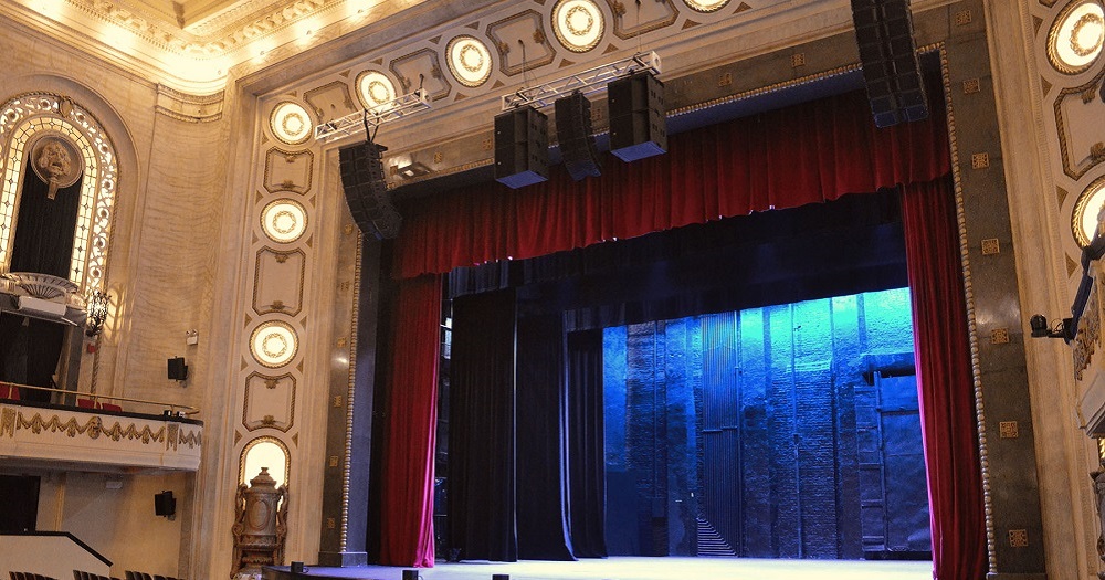 L-Acoustics Kara II speakers hanging from ornate ceiling.