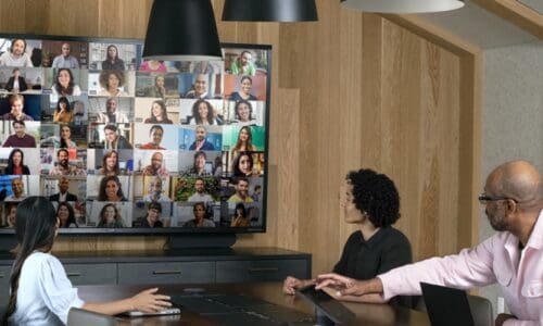 People in a conference room interacting with remote participants using Microsoft Teams Rooms.