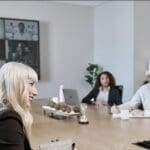 In-office participants engaging with remote workers at a meeting.