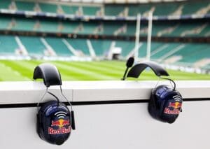 Headsets with Red Bull hanging on arena stand.