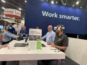 People trying out VR headsets at InfoComm booth.