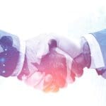Two people shaking hands with silhouettes of team members superimposed inside the handshake.