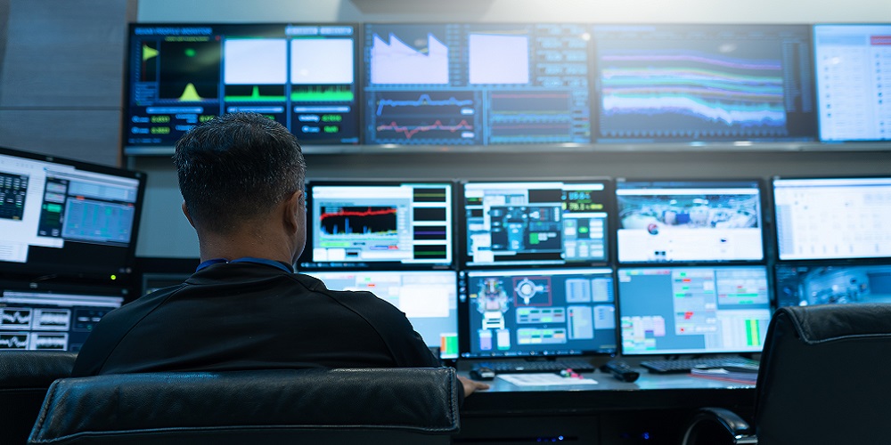 Person in a government control room conducting surveillance.