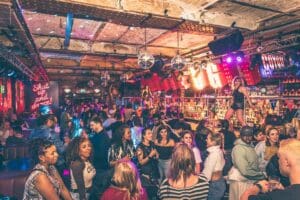 Coyote Ugly Camden bar packed with enthusiastic crowd dancing away.