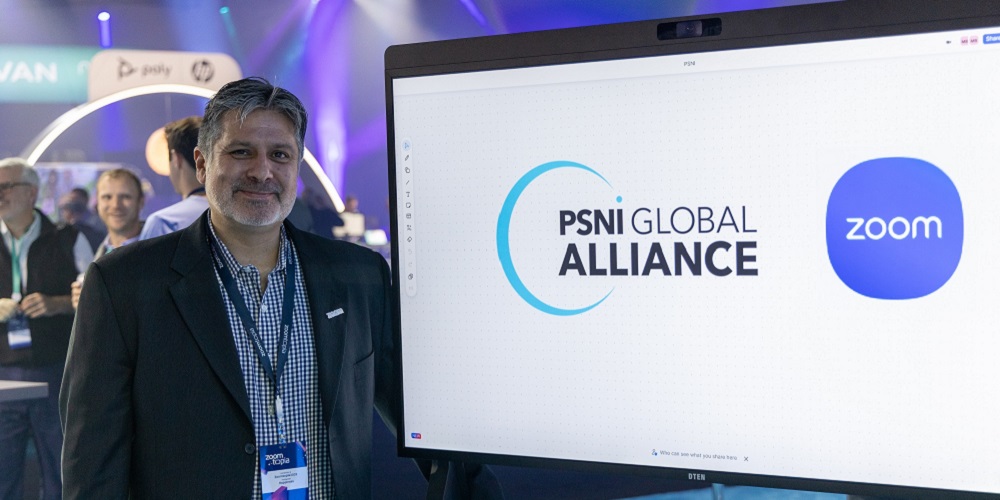 Cary Bran posing with screen that shows the logos of PSNI Global Alliance and Zoom.