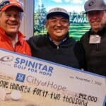 Spinitar employees posing with Golf for Hope check.
